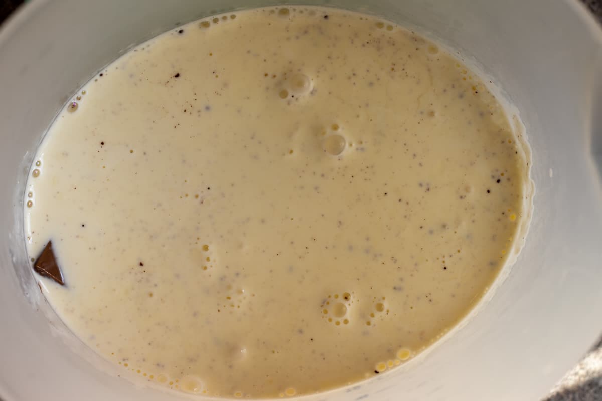 the warm cream is poured on chocolate