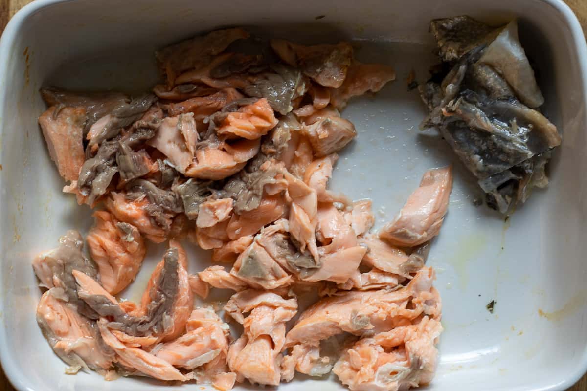 cooked salmon is flaked with a fork