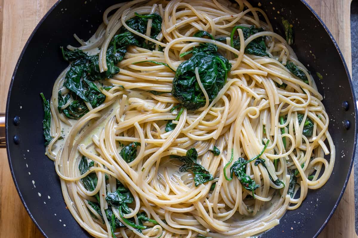 the precooked pasta is added to the sauce along with some water