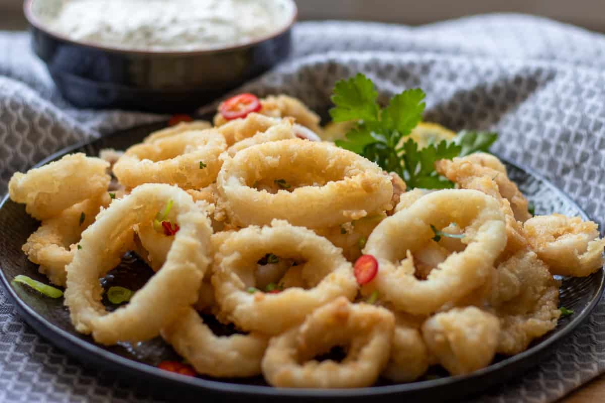 Crispy fried calamari rings served with tartar sauce on the side.