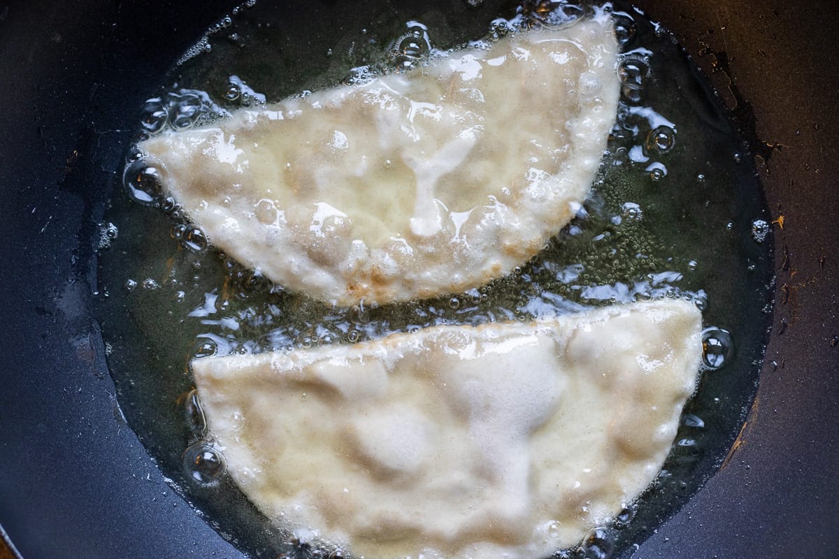 frying the pastries in hot oil