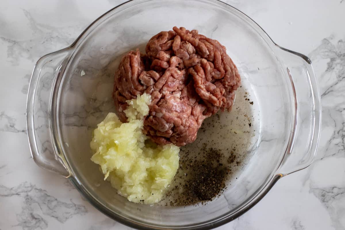 Mince, onion and spices are placed in a bowl for making the filling