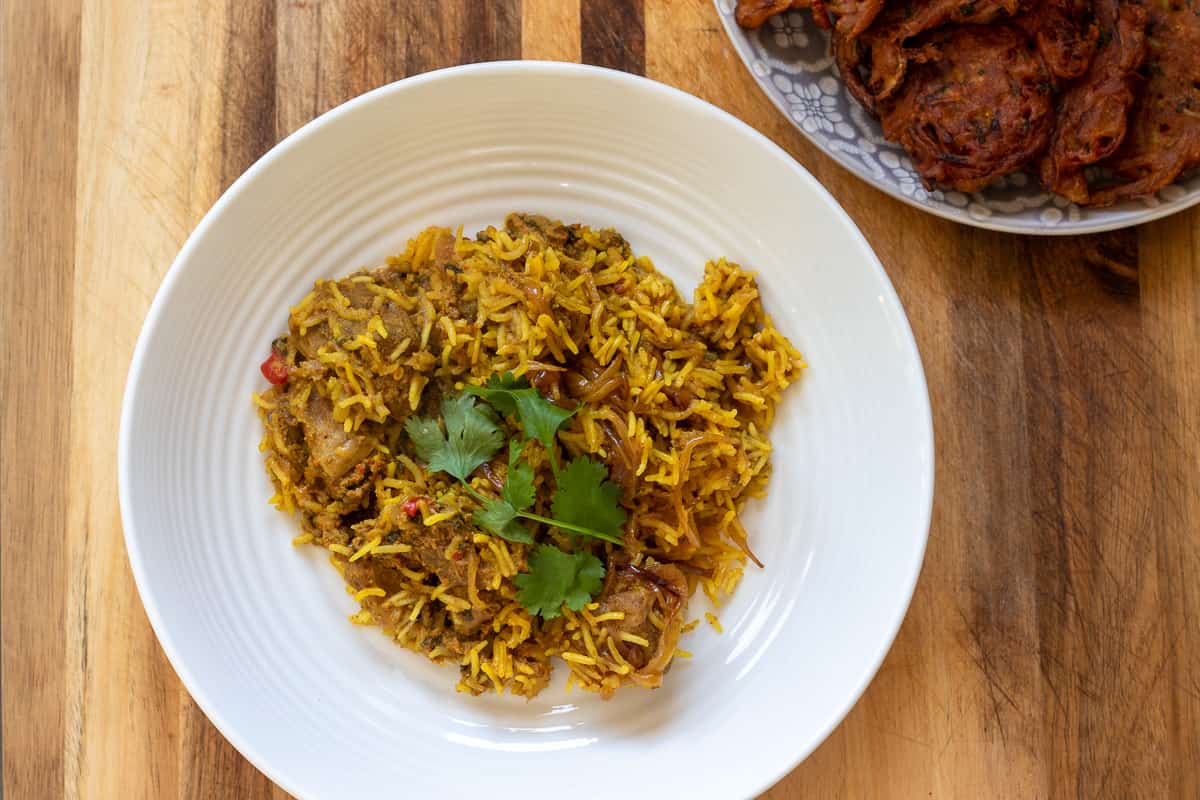 Hyderabadi mutton biryani served with onion hajis