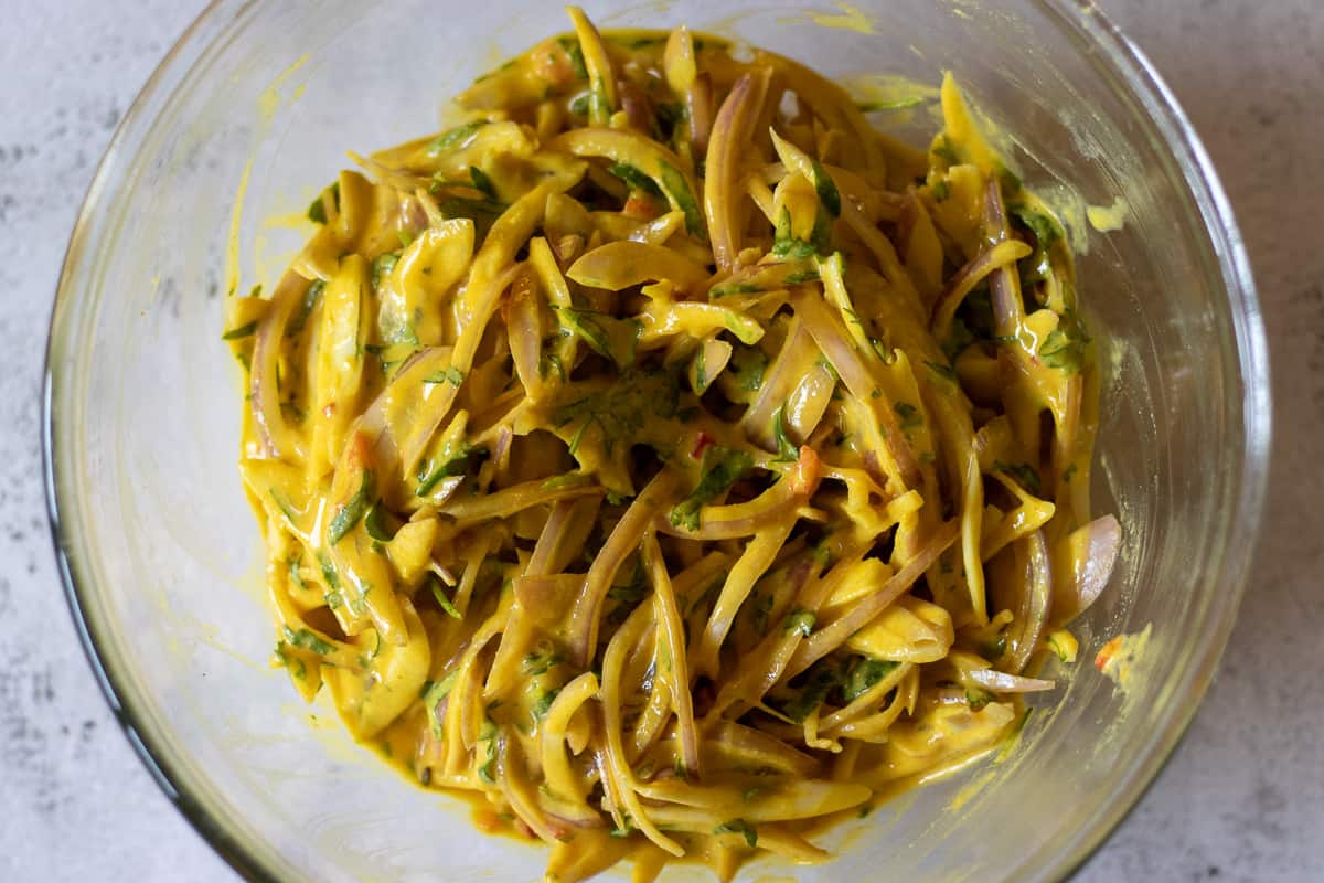 sliced onions are stirred in the batter