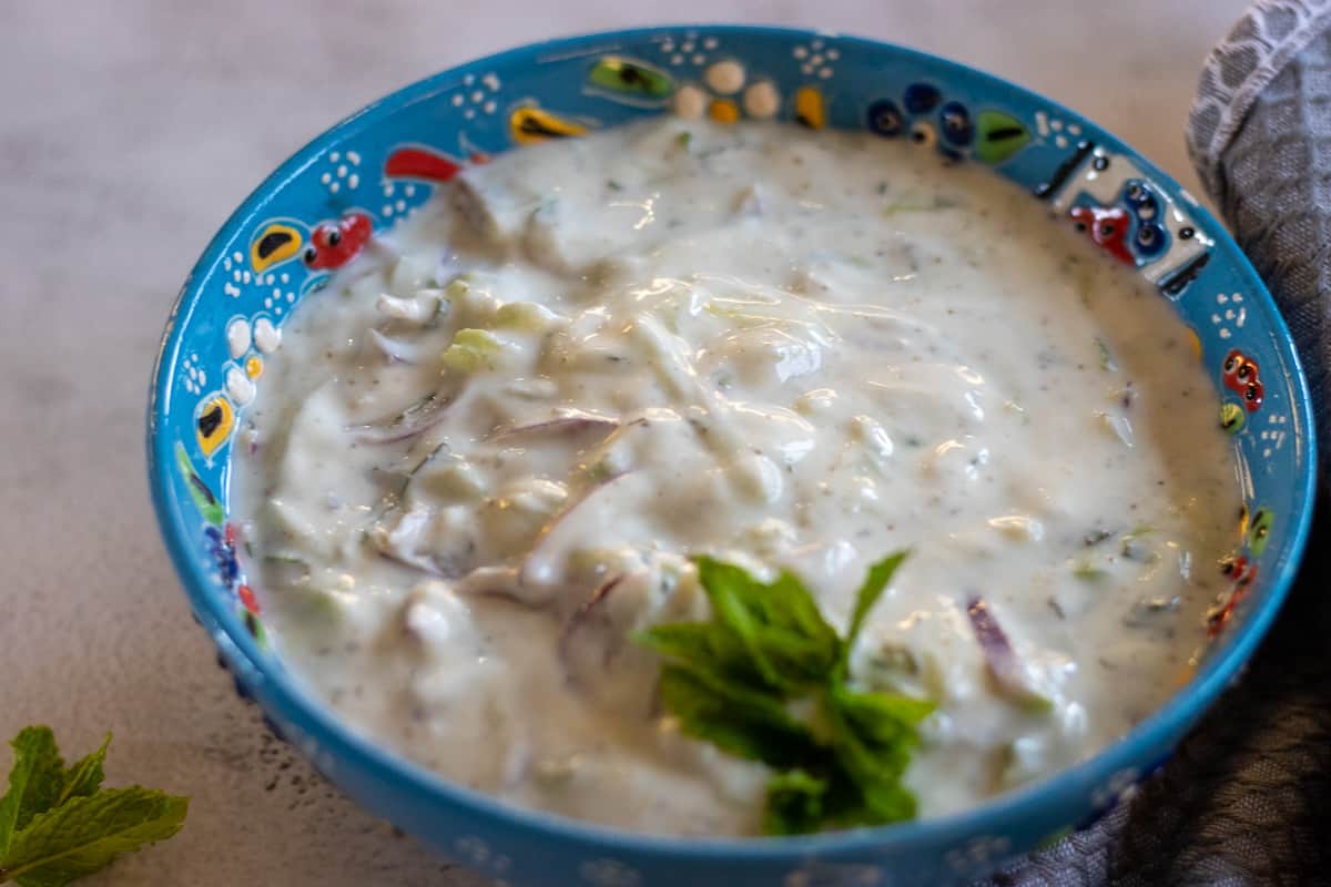 onion raita garnished with mint