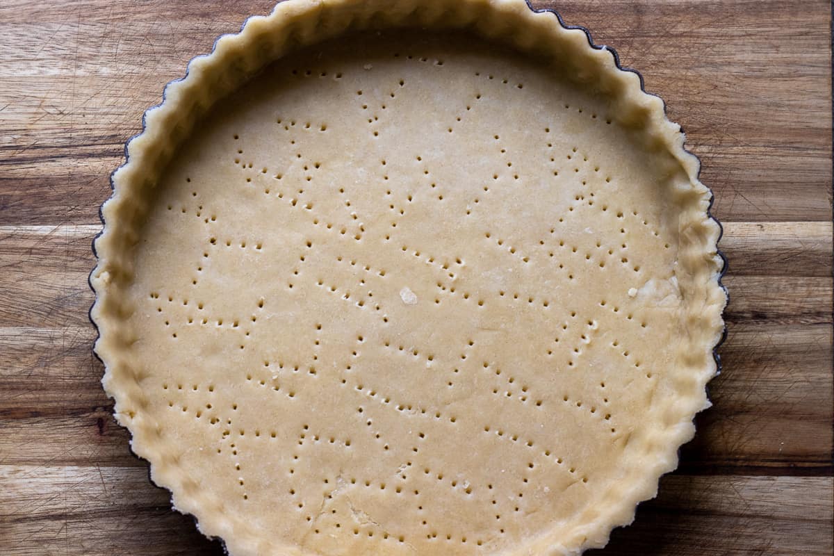 the rolled out dough circle in a flutter pan