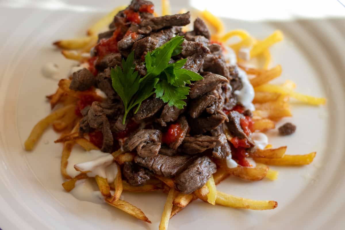 cokertme kebabi is served on a white plate