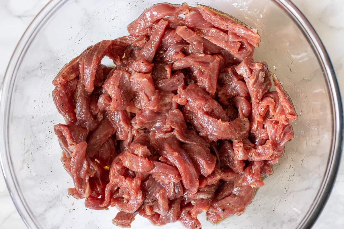 Julien cut meat is marinated in a bowl