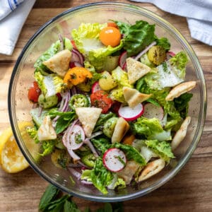 A salad with tomatoes, lettuce and other vegetables