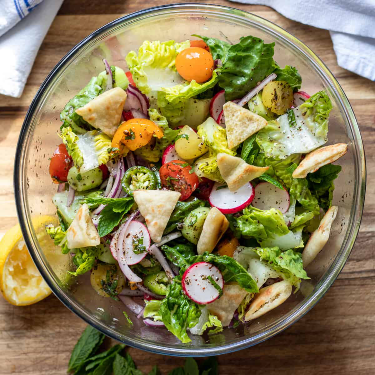 A salad with tomatoes, lettuce and other vegetables