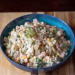 Russian Salad in a bowl with fresh dill leaves