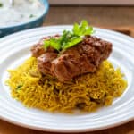 2 pieces of tandoori chicken thighs served on rice