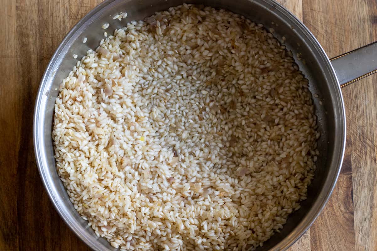 Sautéing the rice before adding the wine