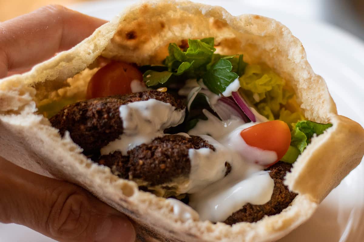 pita bread stuffed with falafel, salad, and tahini dressing