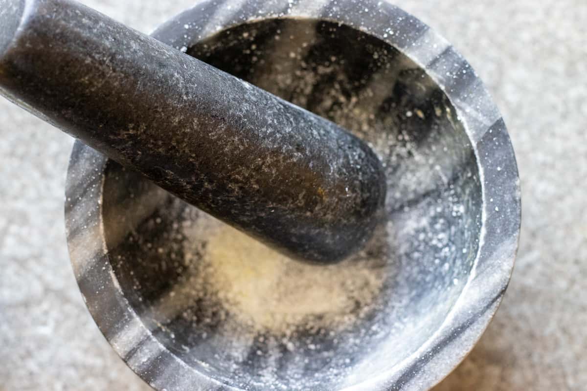 mastic com turned into a powder in a pestle and mortar