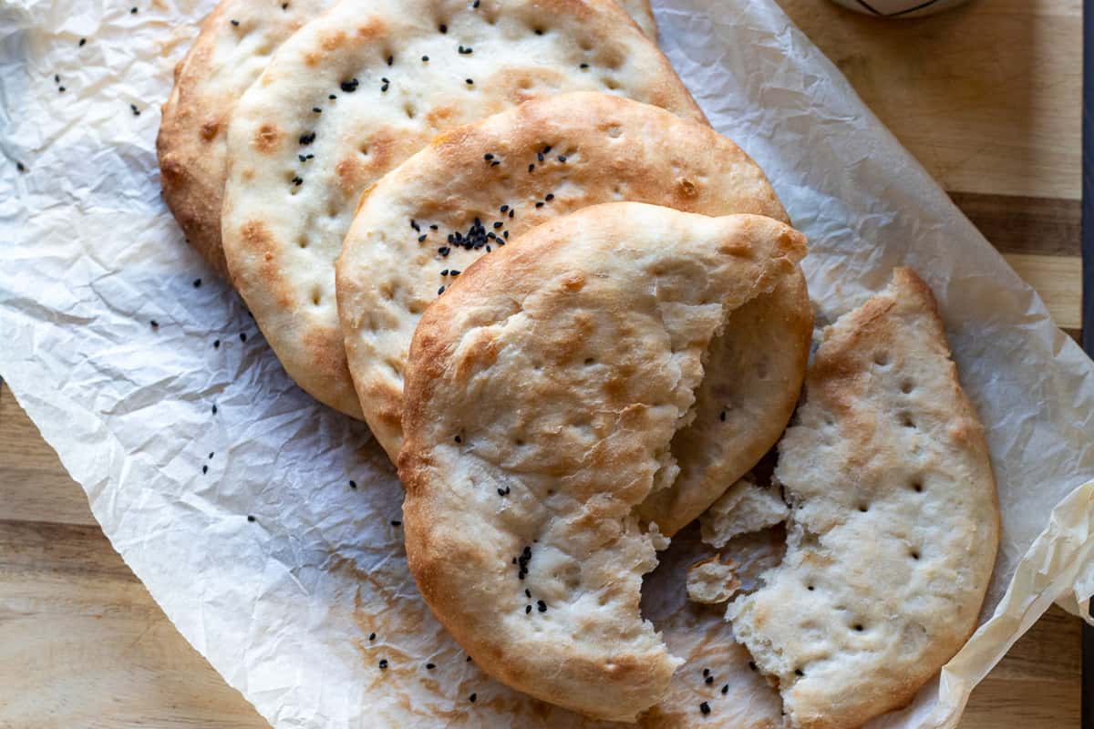 four pieces of Pakistani roghni naan bread