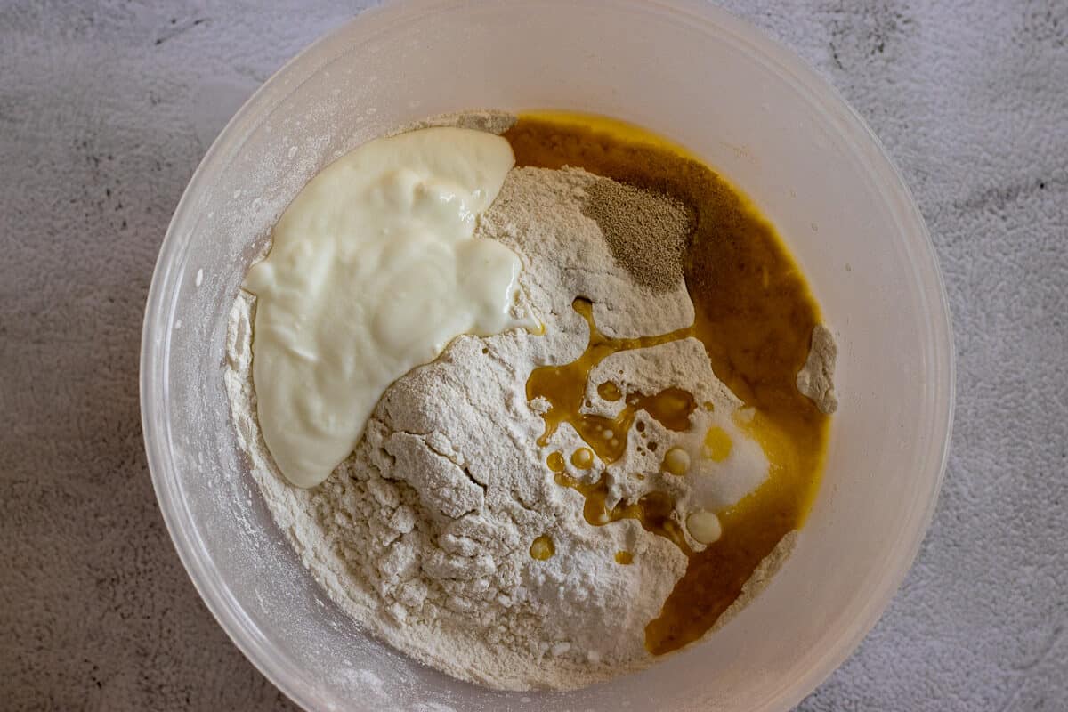 Ingredients for roghni naan dough are placed in a bowl
