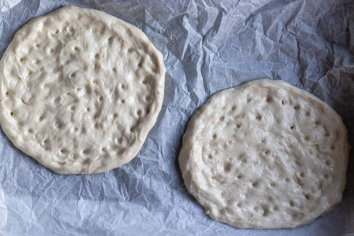 2 dough circles are marked and placed on a tray