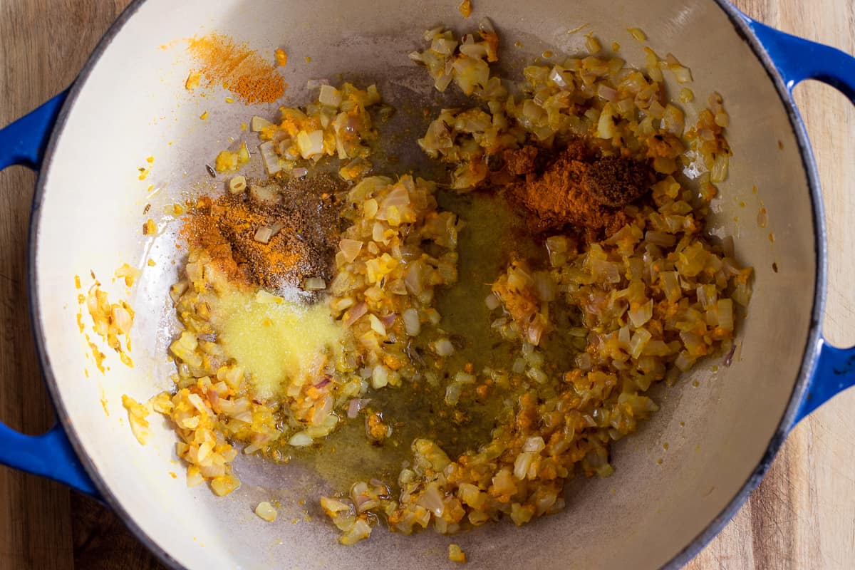 Sautéing the spices until fragrant