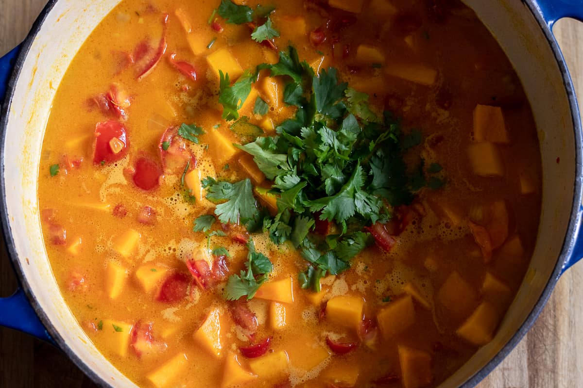 stock and coconut milk are poured in the pan