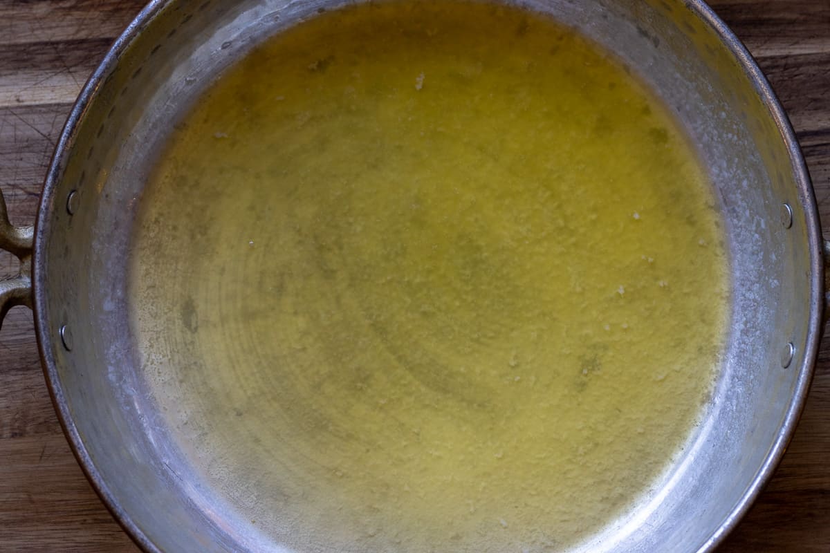 melting the butter in a copper pan