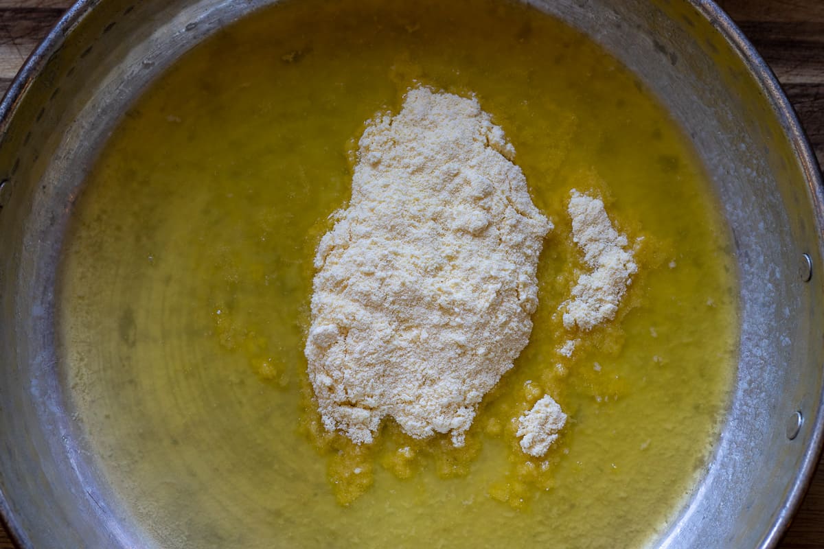 adding the cornmeal to melted butter