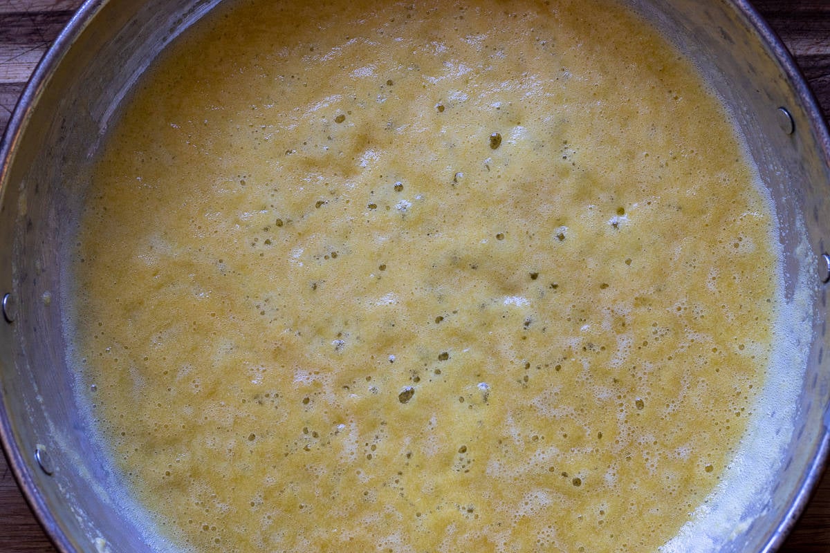 Sautéing the cornmeal until it turns slightly brown
