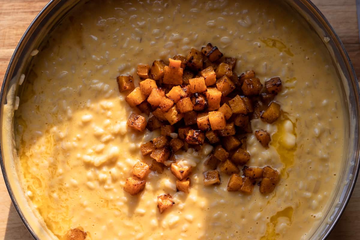 adding roasted pumpkin to risotto