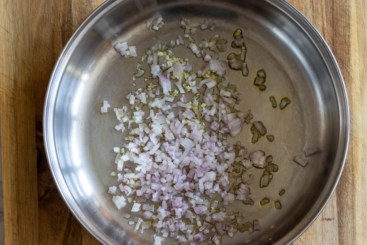 Sautéing shallots with olive oil in a pan
