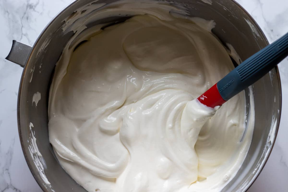 whipped cream is folded into sour cream