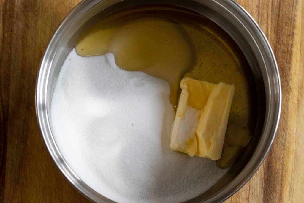 Honey, butter, and sugar are placed in a pan.