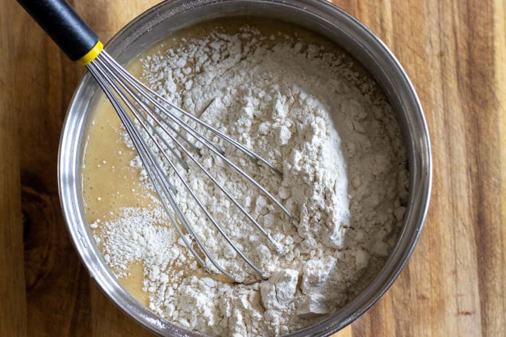 The flour is added to the honey egg mixture.