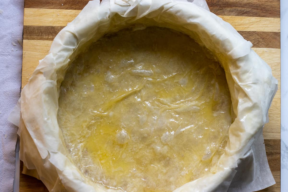 the rest of the filo pastries are layered on top of the walnuts
