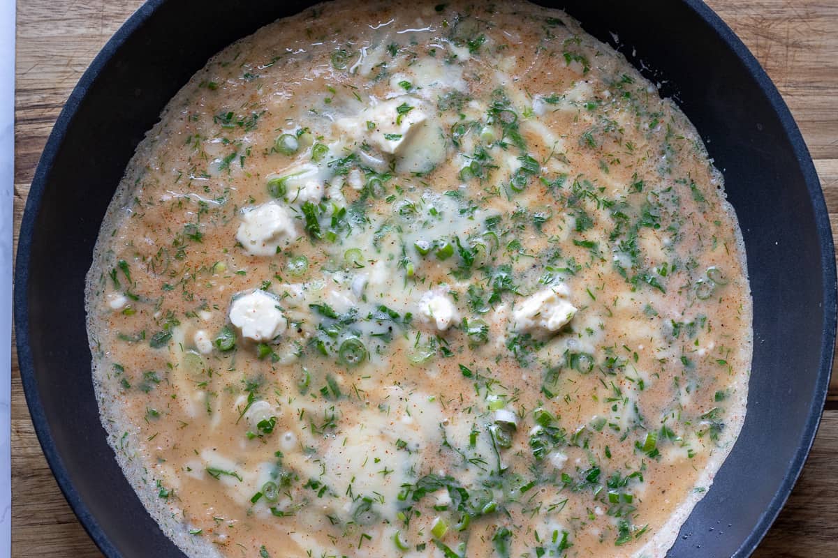 ladle of the mixture is poured into a hot pan