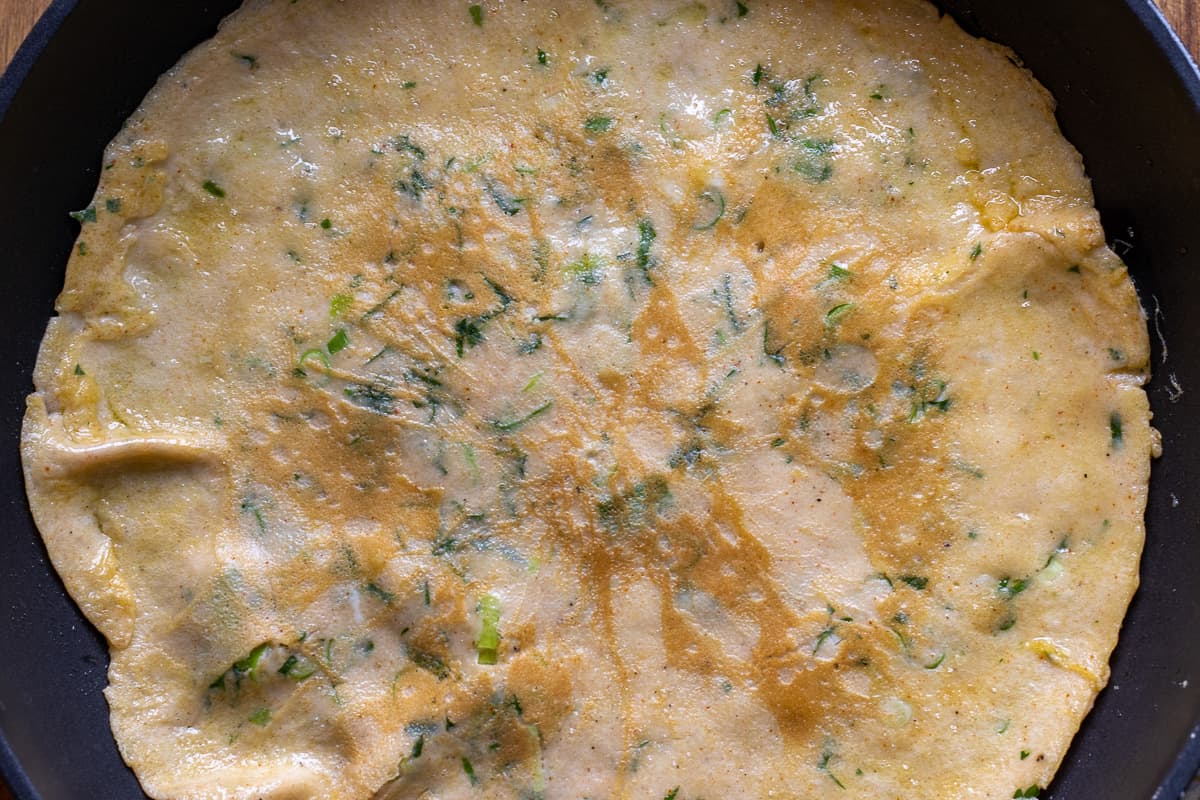 the omelet is flipped to cook the other side