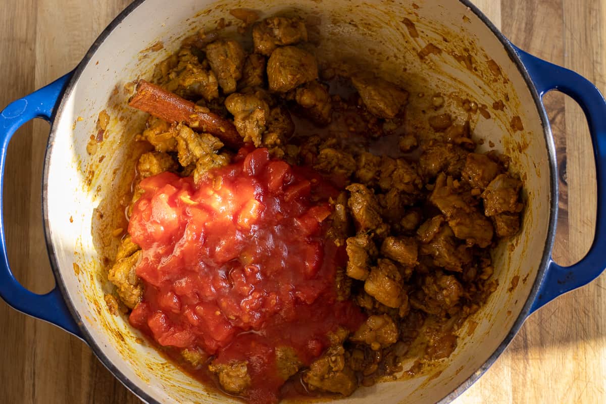 tinned tomatoes are added to the Dutch oven