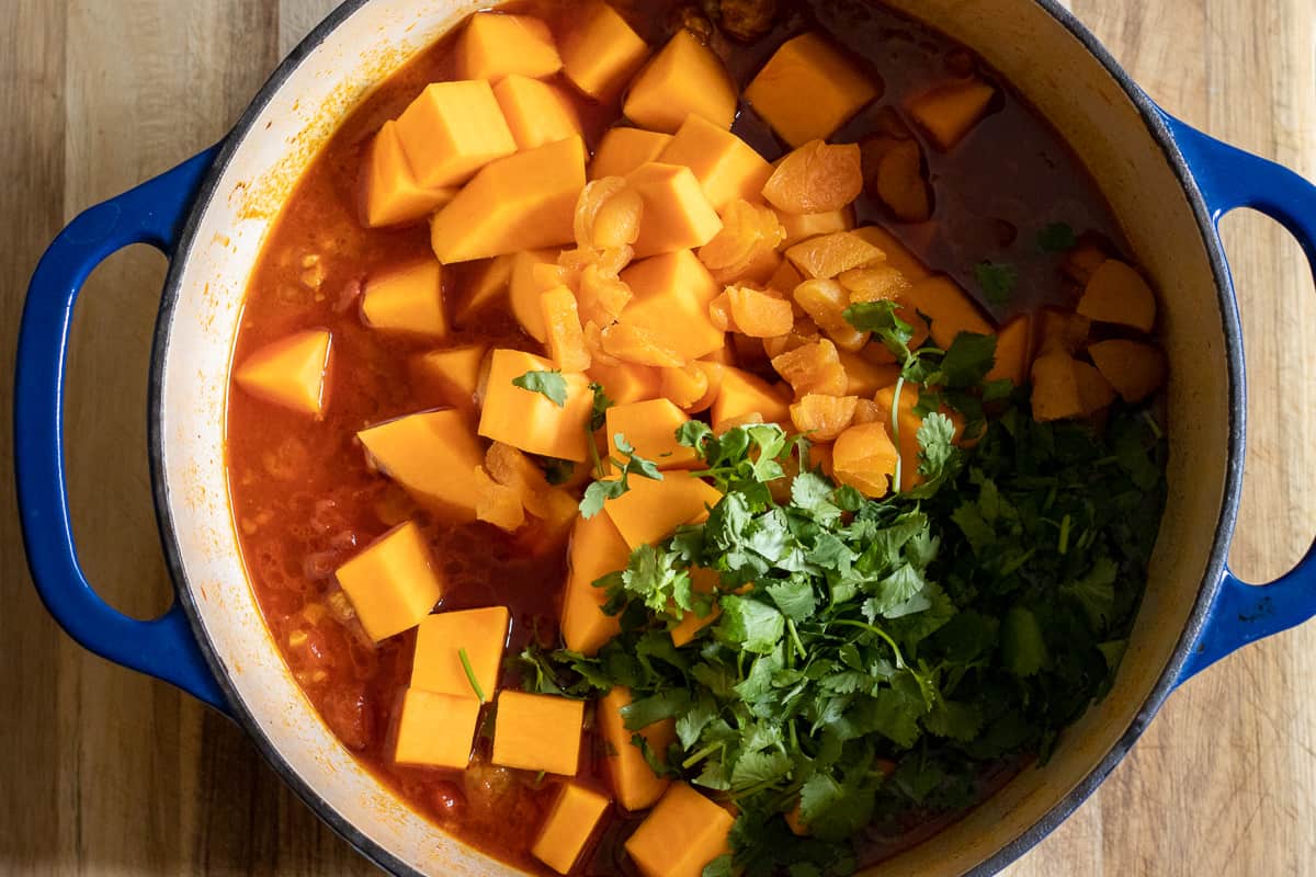 diced squash and coriander are added to the stew