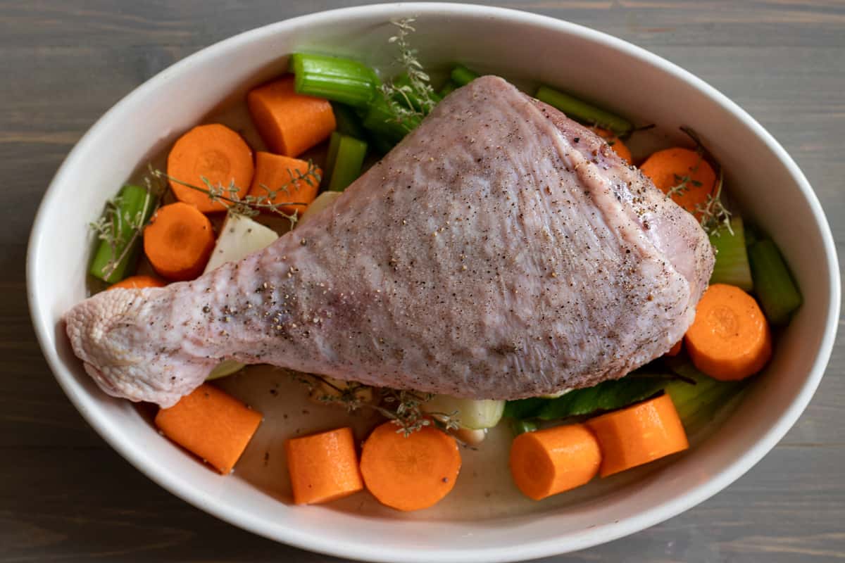 turkey leg is placed on top of vegetables