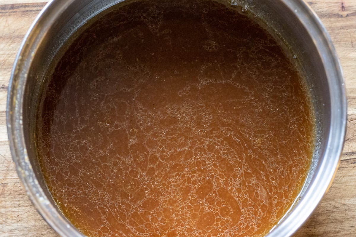 the gravy for Perfect Roast Turkey Recipe - Easy Method is transferred into a saucepan