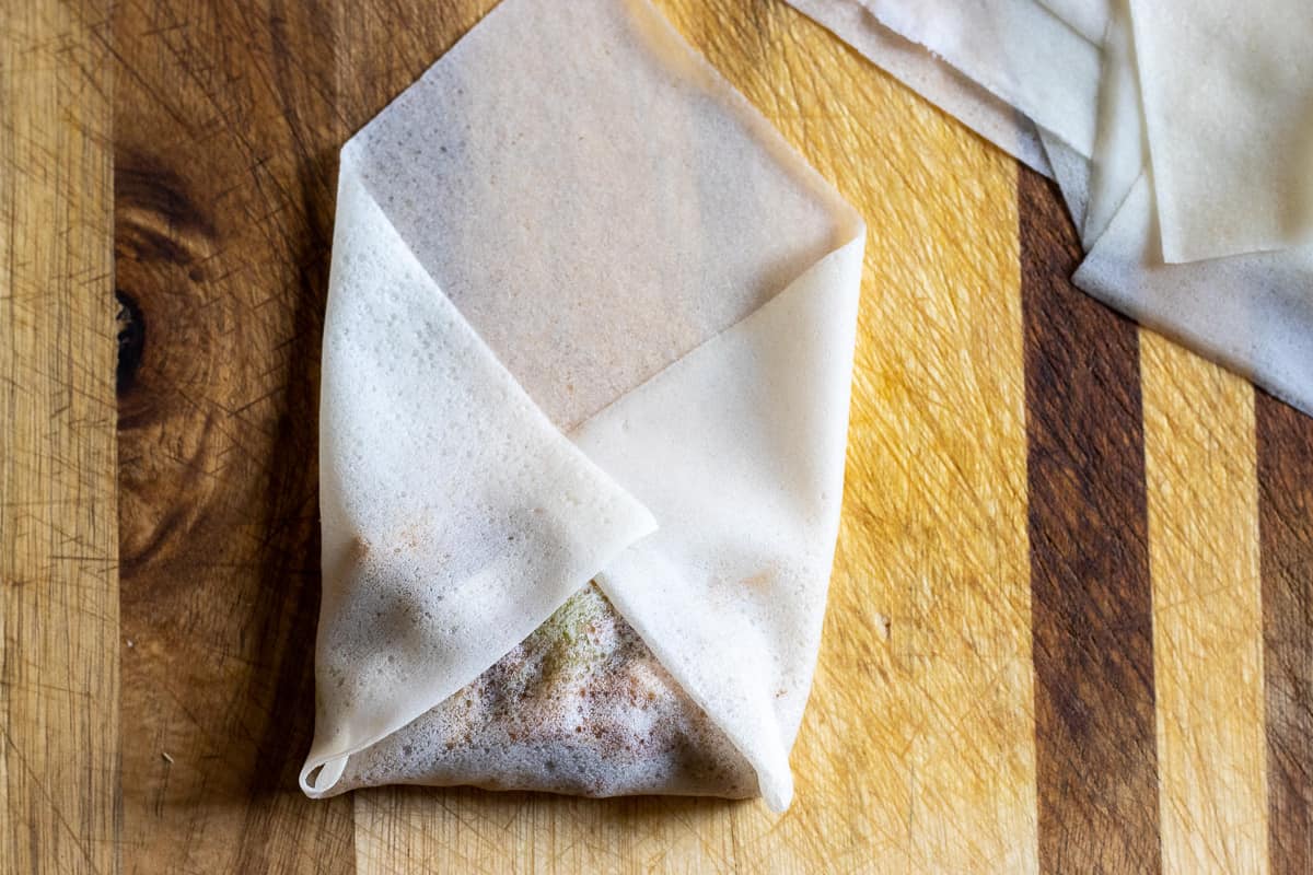 the sides of the wrapper are folded over the duck filling