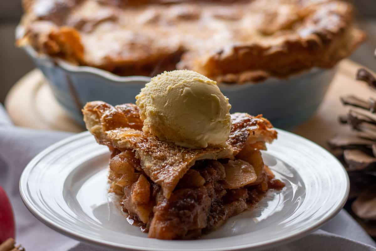 a slice of puff pastry apple pie served with ice cream