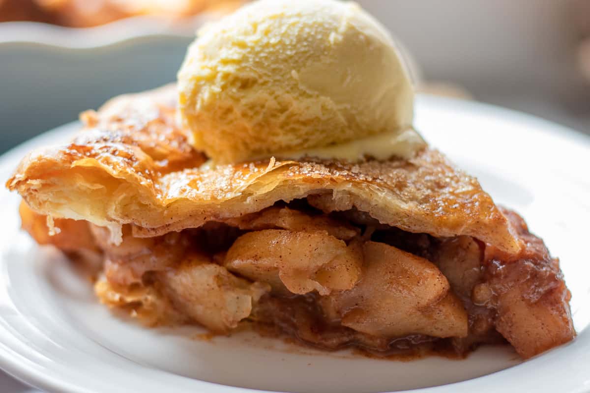 a slice of puff pastry apple pie served with iceceam