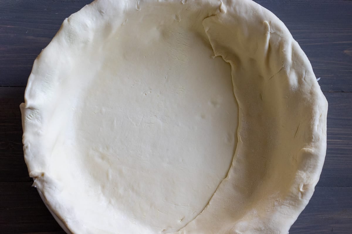 the puff pastry is rolled out and placed on a pie dish