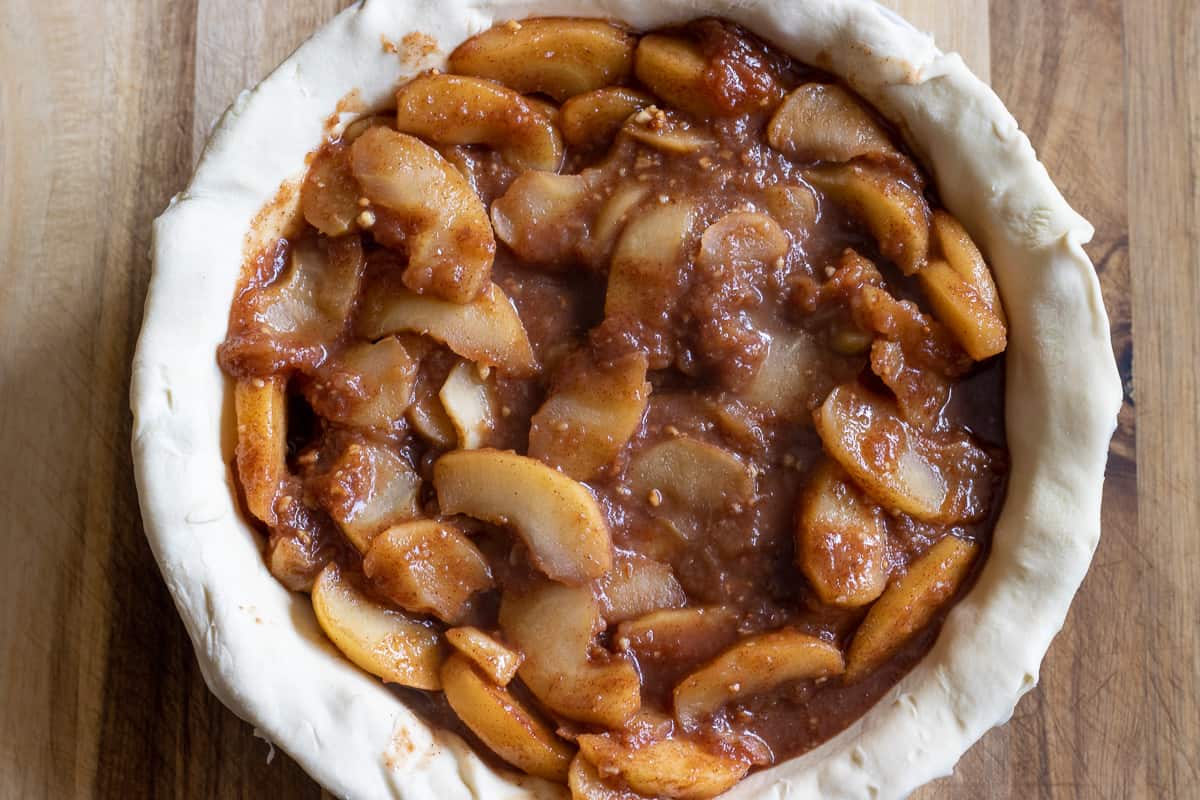 cooked apples are placed on puff pastry crust