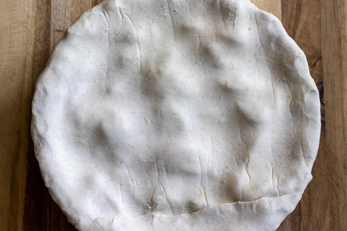 the apple filling is covered with rolled out puff pastry