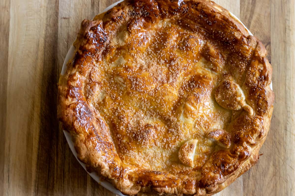 apple pie is baked until the crust is golden