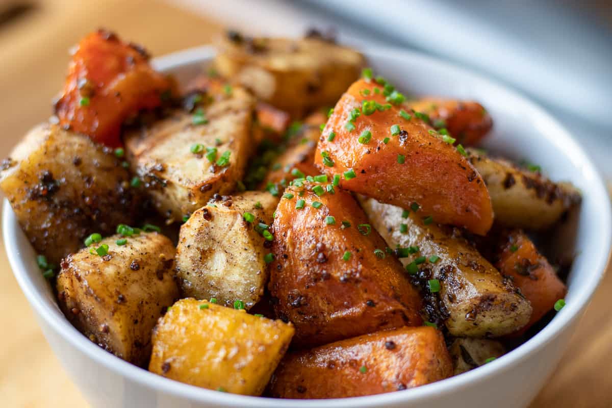 honey roasted carrots and parsnips are served in a bowl