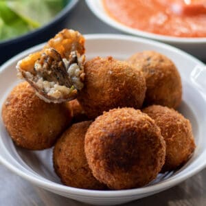 7 pieces of arancini rice balls in a bowl