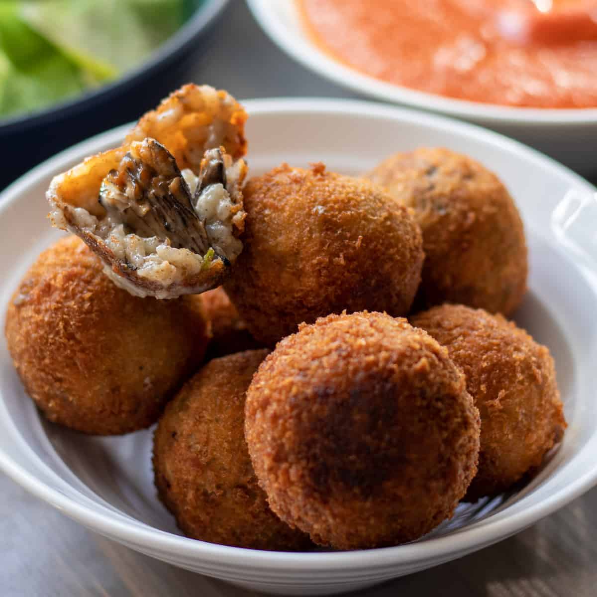 7 pieces of arancini rice balls in a bowl