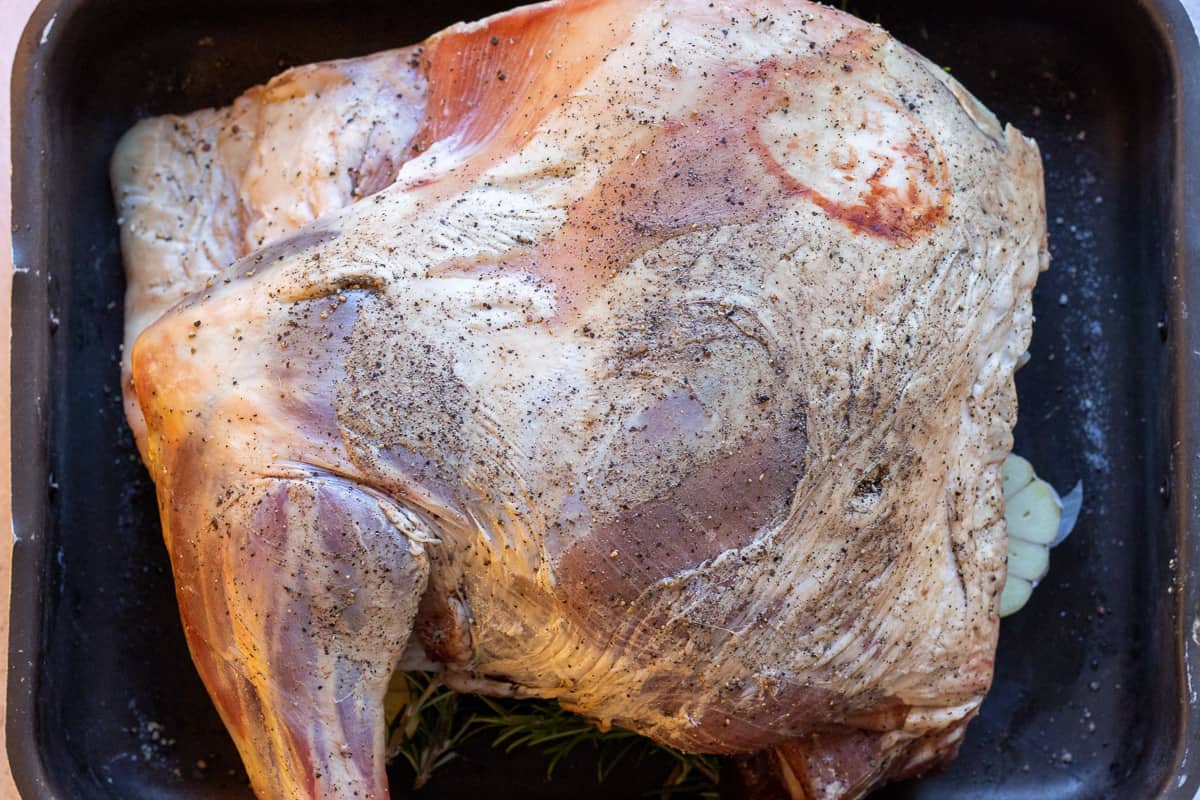 lamb shoulder is placed on top of the vegetables